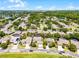 Drone shot exhibiting a home in a golf community with mature trees and a nearby lake at 10033 Hart Branch Cir, Orlando, FL 32832
