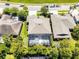 Aerial photograph displays a home's backyard and screened in pool amidst a verdant neighborhood at 10033 Hart Branch Cir, Orlando, FL 32832