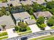 Aerial view of a two-story home with a well-manicured lawn, mature trees, and a two-car garage at 10033 Hart Branch Cir, Orlando, FL 32832