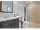 Well-lit bathroom with modern vanity, patterned tile, and step-in shower at 10033 Hart Branch Cir, Orlando, FL 32832