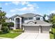 Stunning two-story home featuring a spacious three-car garage and well-manicured front lawn at 10033 Hart Branch Cir, Orlando, FL 32832