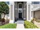 Inviting entryway with a covered front porch and stylish architectural details at 10033 Hart Branch Cir, Orlando, FL 32832