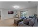 Spacious living room featuring comfortable seating, a large television, and balcony access at 10033 Hart Branch Cir, Orlando, FL 32832