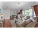 Cozy living room featuring hardwood floors, stylish furniture, and sliding door access to outdoor space at 10033 Hart Branch Cir, Orlando, FL 32832