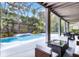 Inviting outdoor patio with comfortable seating, overlooking a sparkling pool and beautifully landscaped yard at 10033 Hart Branch Cir, Orlando, FL 32832