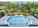 Beautiful pool area is surrounded by lush landscaping and a screened enclosure at 10033 Hart Branch Cir, Orlando, FL 32832