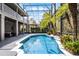 Gorgeous pool area featuring lush landscaping, screened enclosure, and access to indoor and outdoor living spaces at 10033 Hart Branch Cir, Orlando, FL 32832