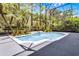 Stunning pool with rock water feature surrounded by vibrant tropical landscaping in a screened enclosure at 10033 Hart Branch Cir, Orlando, FL 32832