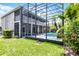 Outdoor screened-in pool area featuring a covered lanai with lush landscaping and a beautiful pool at 10033 Hart Branch Cir, Orlando, FL 32832