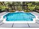 Stunning in-ground pool with tropical landscaping, surrounded by a screened enclosure for year-round enjoyment at 10033 Hart Branch Cir, Orlando, FL 32832