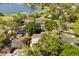 Community aerial view with lake and surrounding homes with mature trees at 109 Romney Marsh Rd, Longwood, FL 32779