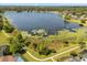 Aerial view of a lake and surrounding homes with pathways at 109 Romney Marsh Rd, Longwood, FL 32779