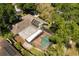 Aerial view of the property with a private pool, screened-in lanai, solar panels, and fenced yard at 109 Romney Marsh Rd, Longwood, FL 32779