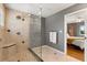 Tiled walk-in shower with glass, and neutral walls with view to an adjacent bedroom at 109 Romney Marsh Rd, Longwood, FL 32779