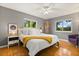 Serene bedroom featuring hardwood floors, ceiling fan, and bright windows at 109 Romney Marsh Rd, Longwood, FL 32779