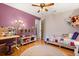 This bedroom features a ceiling fan, colorful quilt, and a built-in desk and bookshelf at 109 Romney Marsh Rd, Longwood, FL 32779