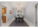 Elegant dining room with chandelier, black table, and seating for four at 109 Romney Marsh Rd, Longwood, FL 32779