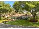 Charming single-story home with mature trees, lush landscaping, and well-manicured lawn at 109 Romney Marsh Rd, Longwood, FL 32779