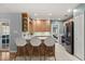 Open-concept kitchen with an island, wooden cabinets, and stainless-steel appliances at 109 Romney Marsh Rd, Longwood, FL 32779