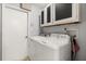 This laundry room features overhead cabinets, a washing machine, and a dryer at 109 Romney Marsh Rd, Longwood, FL 32779