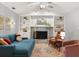 Cozy living room showcasing built-in shelves, a brick fireplace, and comfortable seating at 109 Romney Marsh Rd, Longwood, FL 32779