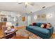 Comfortable living room features a blue sofa, colorful rug, and modern lighting at 109 Romney Marsh Rd, Longwood, FL 32779