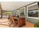 This screened-in patio features wood furniture and views of the back yard at 109 Romney Marsh Rd, Longwood, FL 32779