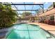 The large in-ground pool is encased in a screened-in patio with a view of mature landscaping at 109 Romney Marsh Rd, Longwood, FL 32779