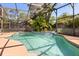 This in-ground pool features lush tropical landscaping and a full screened-in enclosure at 109 Romney Marsh Rd, Longwood, FL 32779