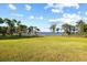 Expansive backyard lawn with beautiful mature trees offering stunning water views at 1112 Orange Ave, Winter Springs, FL 32708