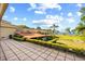 Landscaped backyard featuring a tile patio, manicured lawn, and water view at 1112 Orange Ave, Winter Springs, FL 32708