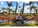 Picturesque backyard with a rock-lined stream cascading into a pond, surrounded by lush landscaping and mature trees at 1112 Orange Ave, Winter Springs, FL 32708