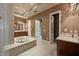 Luxurious bathroom with a soaking tub, separate vanities, and elegant finishes at 1112 Orange Ave, Winter Springs, FL 32708