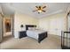 Bedroom with neutral walls and carpet, tray ceiling with ceiling fan, and two double-door closets at 1112 Orange Ave, Winter Springs, FL 32708