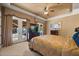 Bedroom featuring a tray ceiling, ceiling fan, and access to a patio with water views at 1112 Orange Ave, Winter Springs, FL 32708