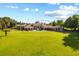 Expansive lawn surrounding an elegant estate, showcasing its grandeur and serene setting under a bright, cloud-filled sky at 1112 Orange Ave, Winter Springs, FL 32708