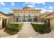Exterior staircase leading to arched entryway with lake view in the distance at 1112 Orange Ave, Winter Springs, FL 32708
