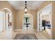 Bright open foyer featuring arched doorways, mosaic tile, and decorative lighting at 1112 Orange Ave, Winter Springs, FL 32708