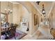 Long hallway showcasing arched doorways, elegant lighting, and decorative accents throughout the home at 1112 Orange Ave, Winter Springs, FL 32708