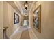 Long hallway adorned with artwork, decorative lighting, and a patterned rug at 1112 Orange Ave, Winter Springs, FL 32708