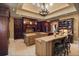 Gourmet kitchen boasts custom wood cabinets, two islands, granite counters, and a beautiful chandelier at 1112 Orange Ave, Winter Springs, FL 32708