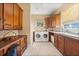 Bright laundry room featuring modern washer and dryer, granite countertops, and ample storage at 1112 Orange Ave, Winter Springs, FL 32708