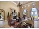Elegant living room featuring a stone fireplace, stylish furniture, and doors leading to outdoor spaces at 1112 Orange Ave, Winter Springs, FL 32708