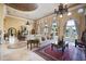 Grand living room with a decorative ceiling, fireplace, elegant sofas, and views of the water at 1112 Orange Ave, Winter Springs, FL 32708