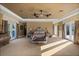 Elegant main bedroom with plush carpeting, tray ceilings, and luxurious furnishings at 1112 Orange Ave, Winter Springs, FL 32708