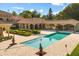 Inviting backyard showcasing a large pool, outdoor kitchen, covered patio, and meticulous landscaping for luxurious outdoor living at 1112 Orange Ave, Winter Springs, FL 32708