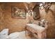Ornate powder room with designer wallpaper and sculpted vanity at 1112 Orange Ave, Winter Springs, FL 32708