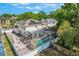 Aerial view of the home with a screened pool and solar panels on the roof at 1188 Foxforrest Cir, Apopka, FL 32712