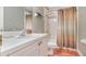Cozy bathroom with single sink vanity, toilet, and shower with decorative curtain at 1188 Foxforrest Cir, Apopka, FL 32712