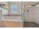 Beautiful bathroom with soaking tub, glass-enclosed shower and stone pebble flooring at 1188 Foxforrest Cir, Apopka, FL 32712